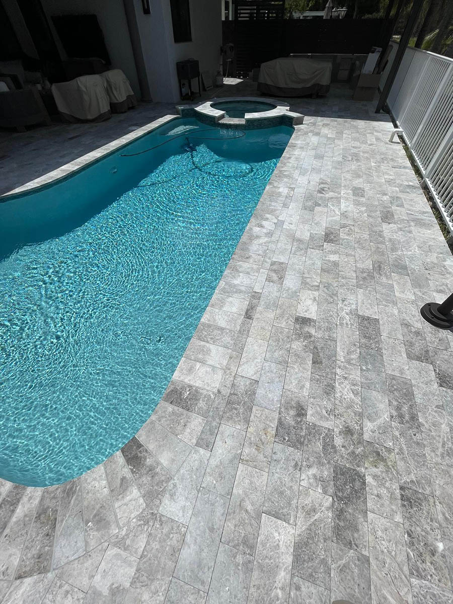 StoneHardscapes marina grey tumbled marble pavers french pattern 12X24 pool deck