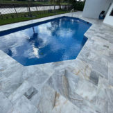 StoneHardscapes Turkish carrara leathered marble pavers pool and deck french pattern
