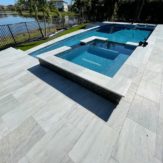 StoneHardscapes aspen white marble pavers pool deck , coping and spa 16x24