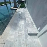 StoneHardscapes Bianca neve tumbled marble pavers pool deck stairs 12x24