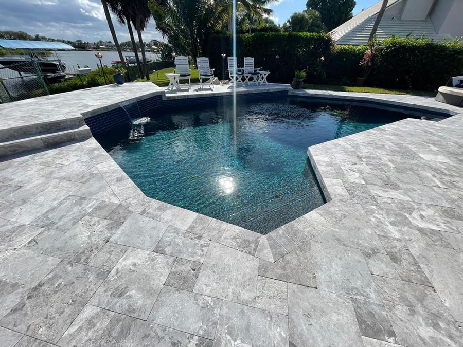 StoneHardscapes french pattern marina grey leathered marble pavers pool deck and coping 6x12