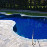 StoneHardscapes Silver Travertine deck and Ice marble coping