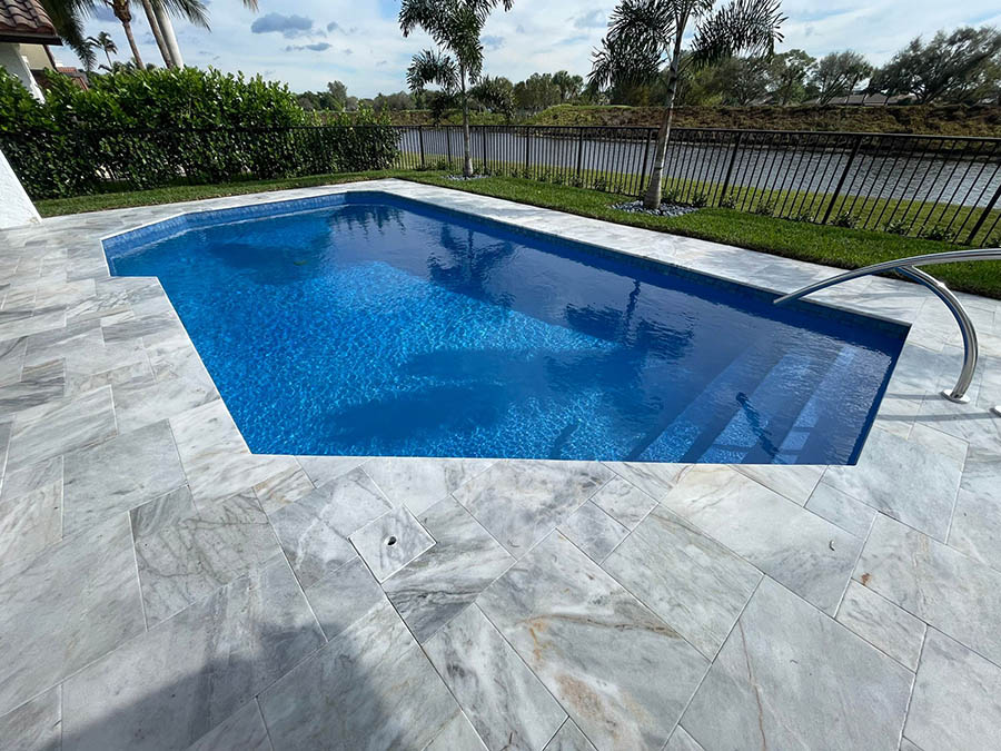 StoneHardscapes Turkish carrara leathered marble pavers pool and deck french pattern