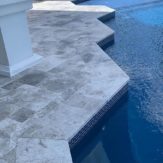 StoneHardscapes marina grey leathered marble pavers pool coping french pattern