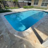 StoneHardscapes mocha premium travertine pavers pool deck and coping french pattern